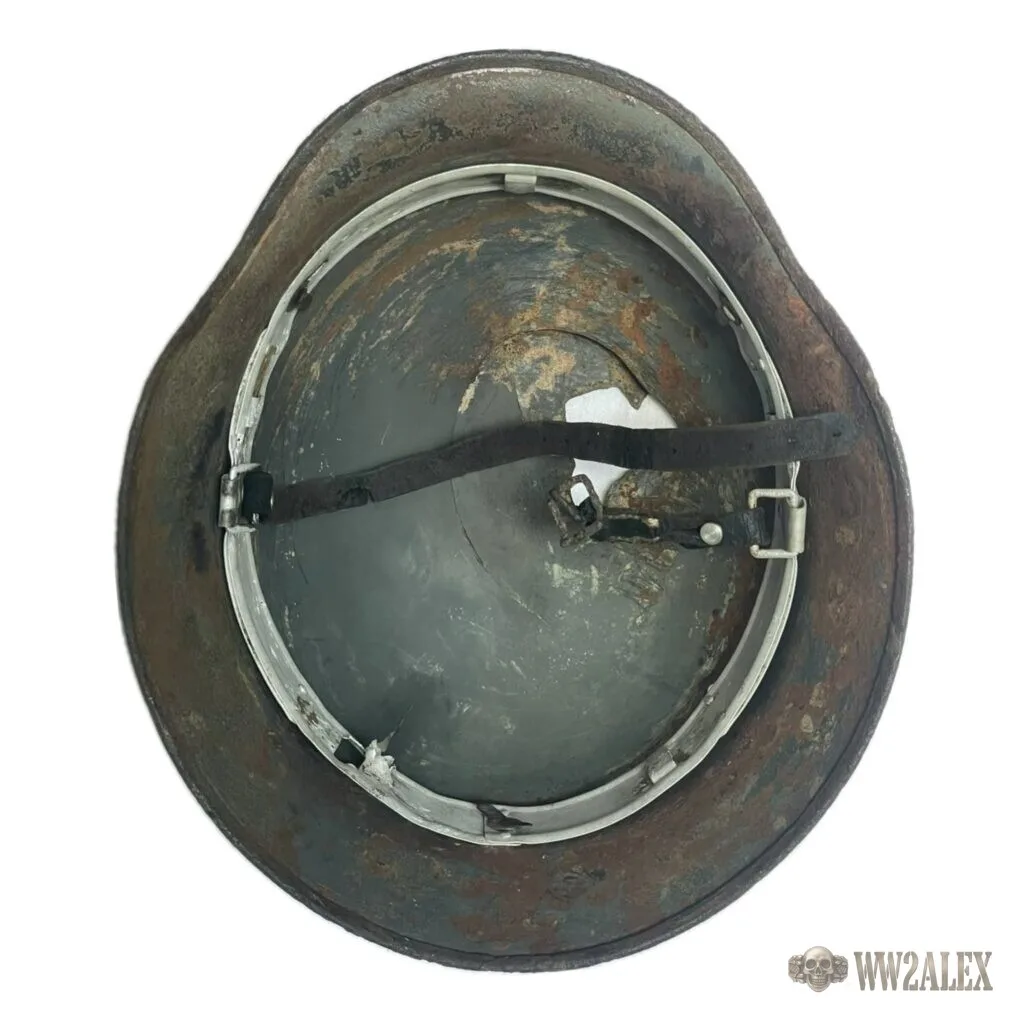 The inside of an M40 helmet with its liner band. Maker codes and size stamps are struck on the inside of the shell