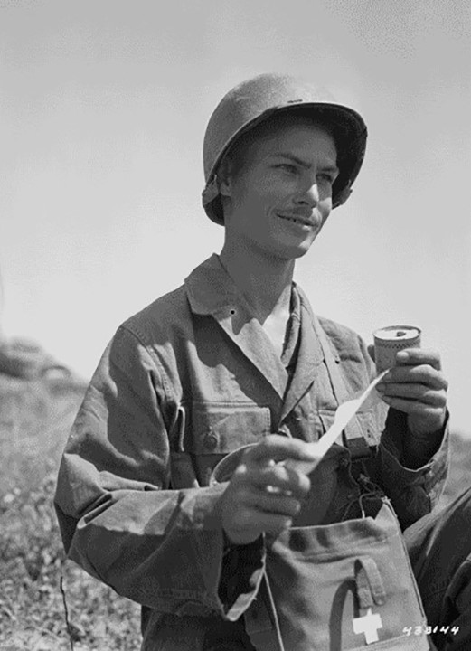 Desmond Doss on Okinawa, 1945, with a medic's kit bag