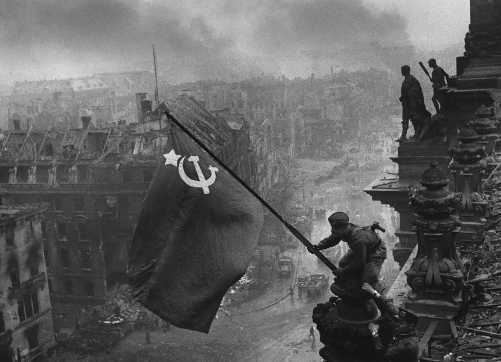 Soviet soldiers raising a flag over the Reichstag, May 1945